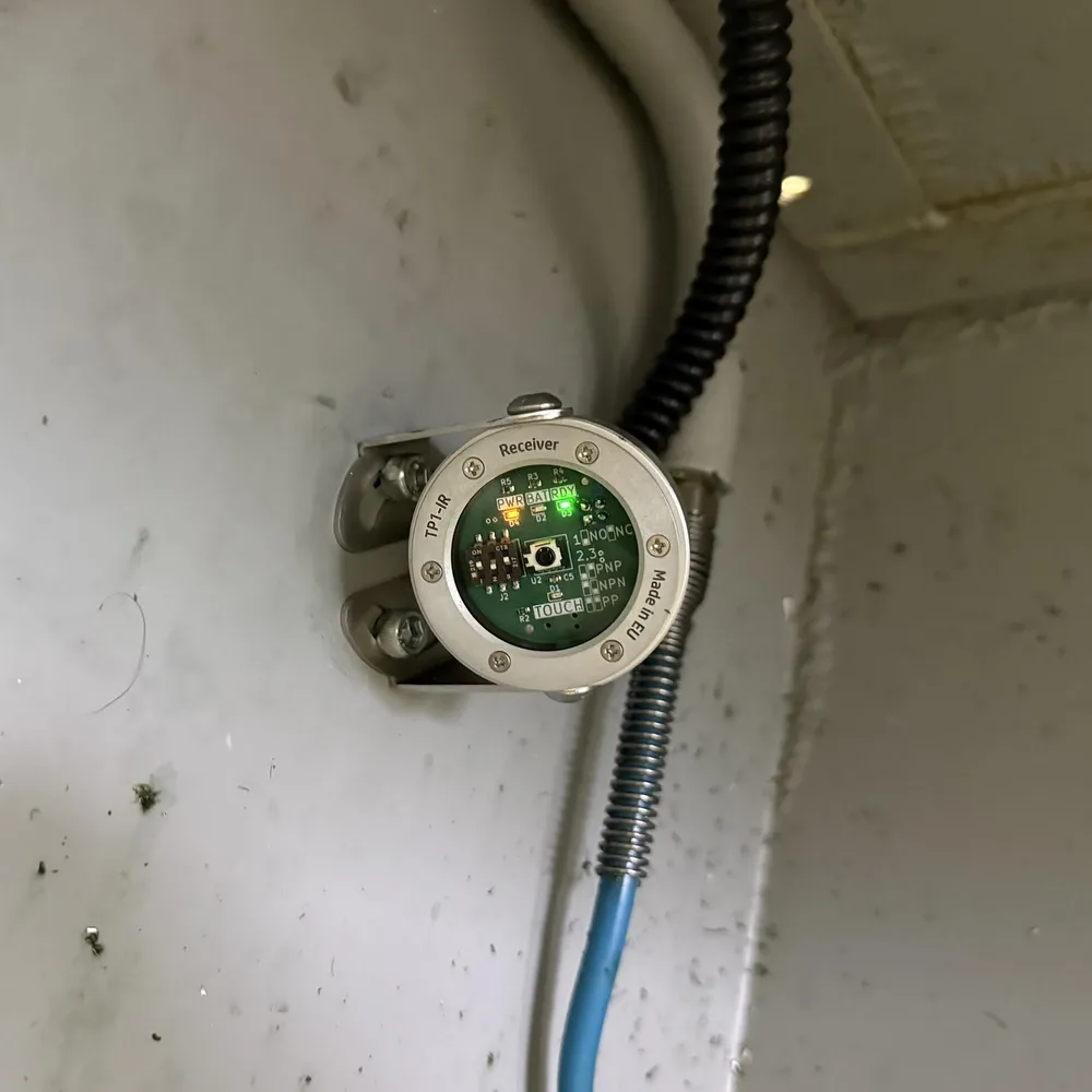 TP1-IR receiver mounted inside a CNC machine enclosure, power and ready LEDs lit
